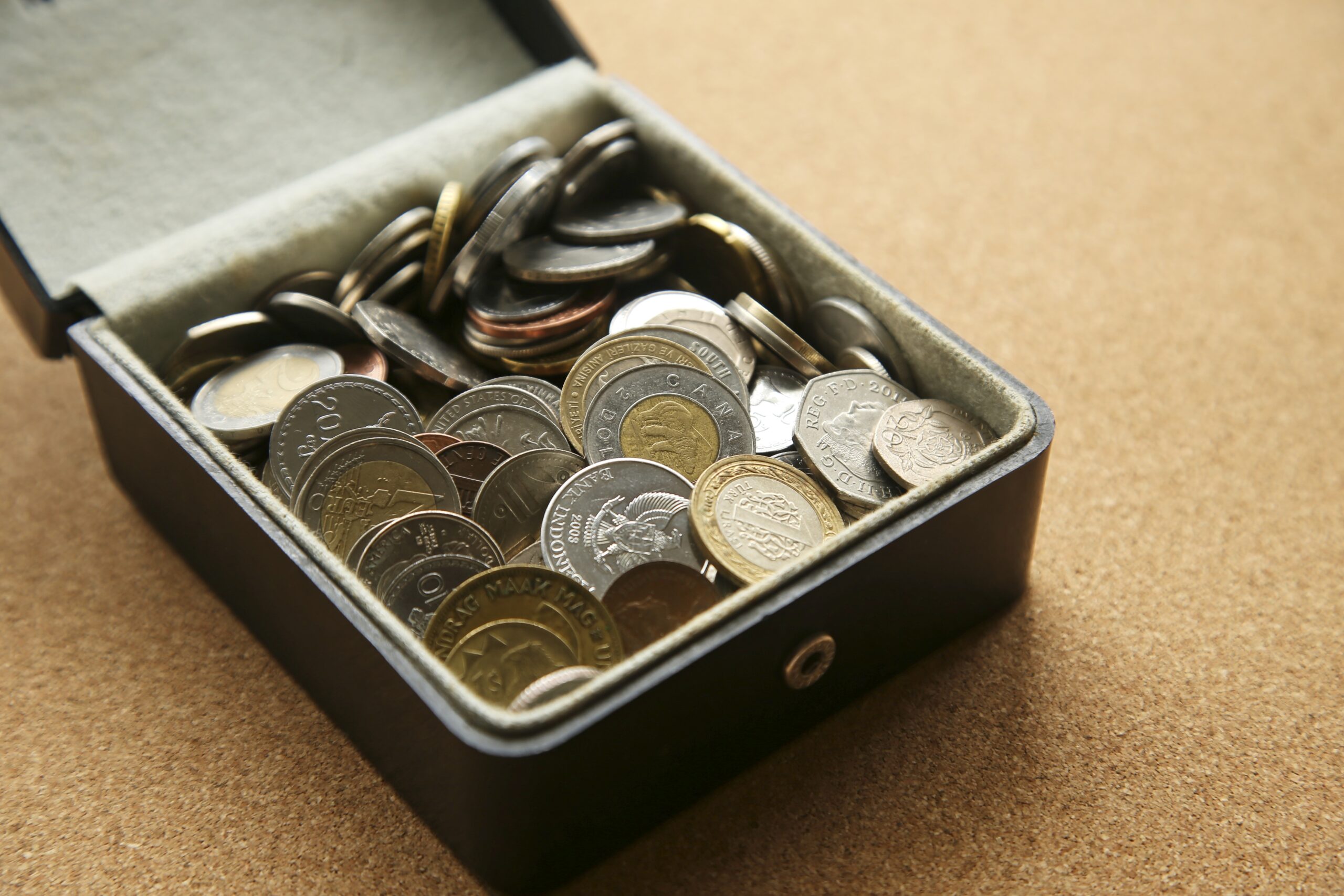 money from around the world inside a box.