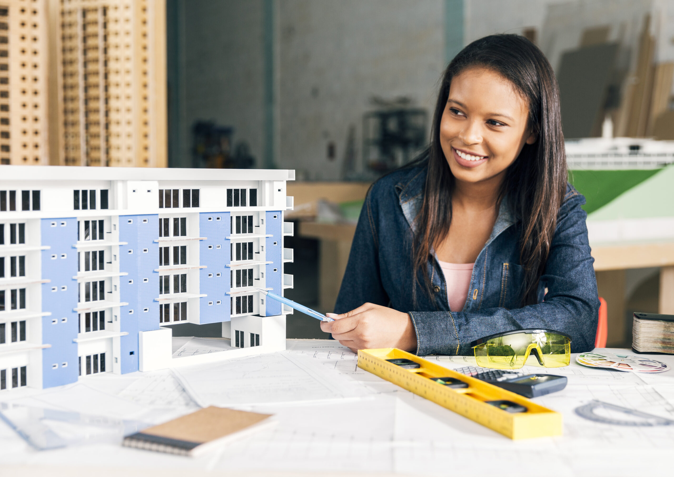 smiling african american woman showing model building